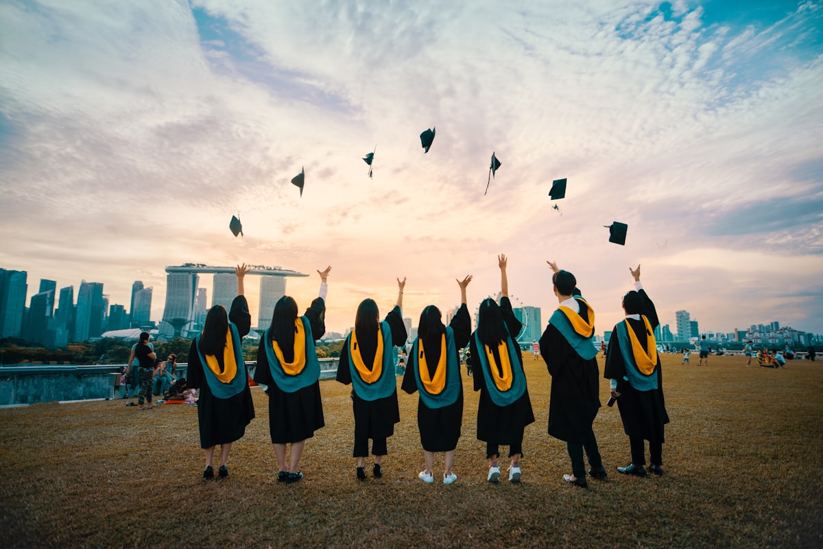 Graduates in academic robes representing the career launchpad that BPhO success provides