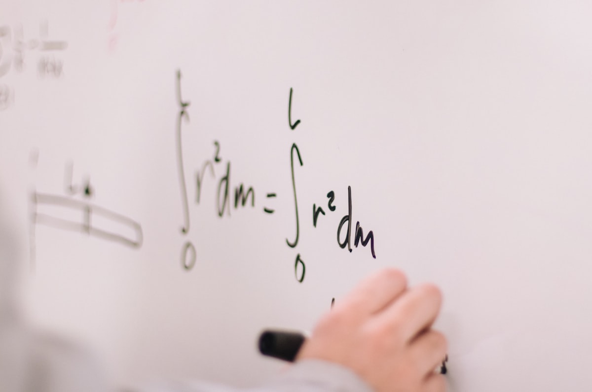Calculus and integrals written on a chalkboard, representing the mathematical language of physics