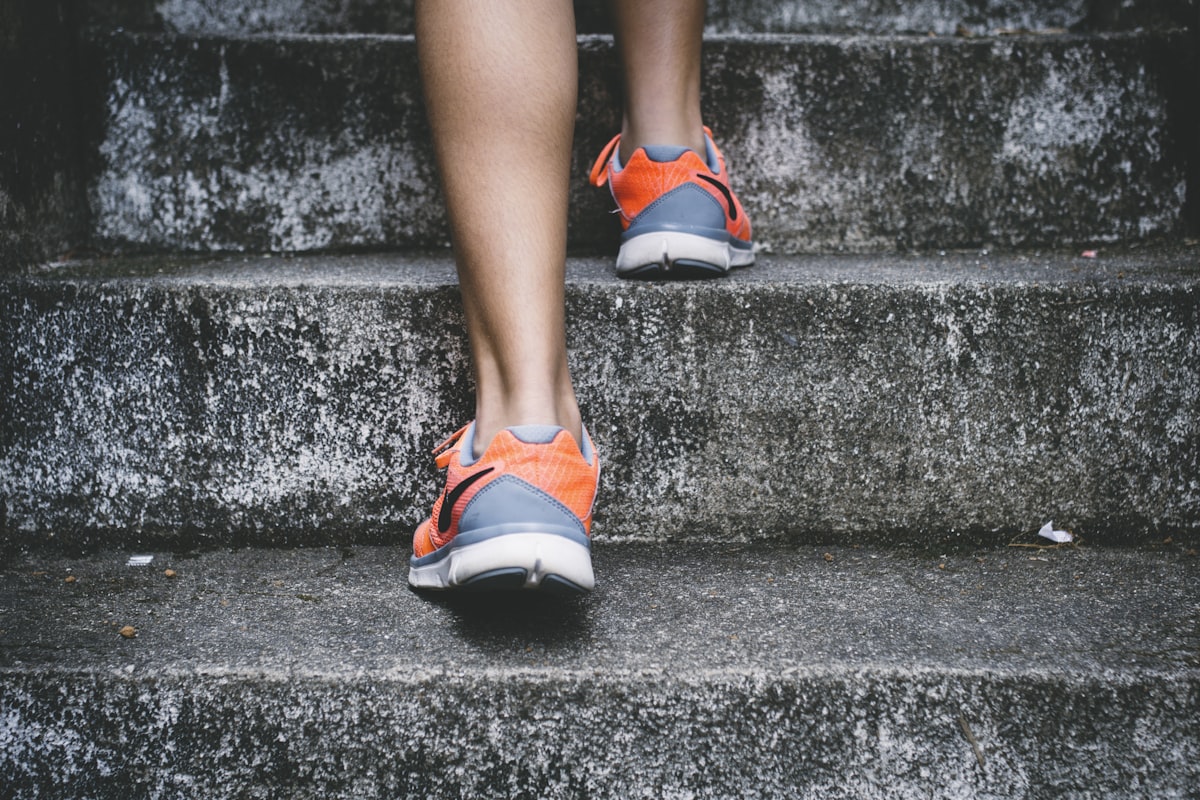 A runner crossing the finish line, representing the culmination of a long journey of effort and growth