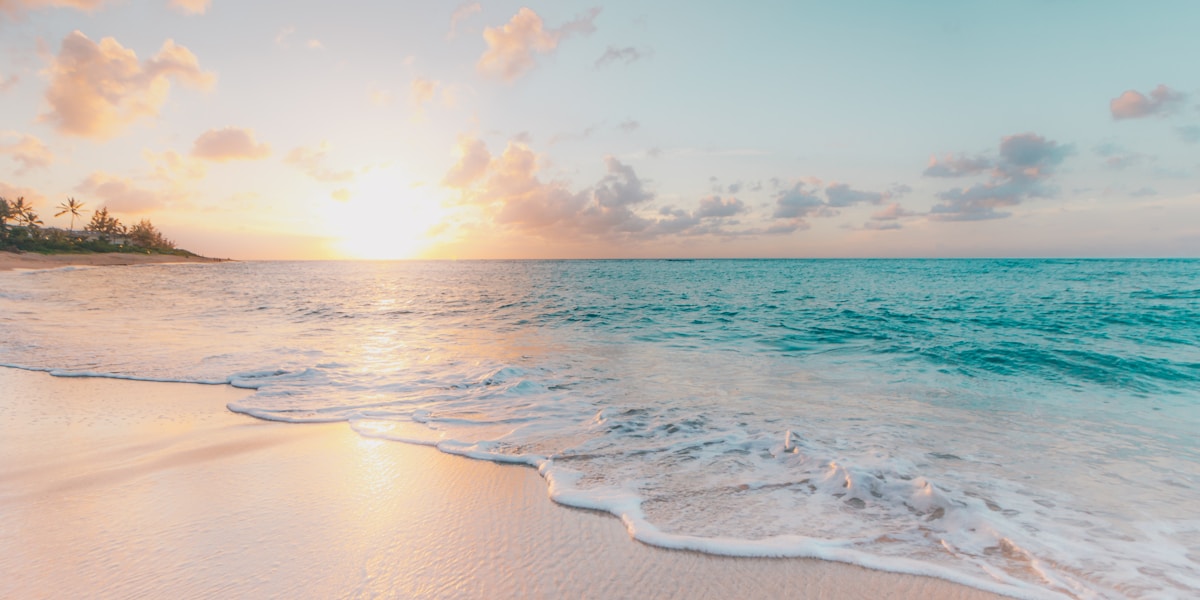 A calm beach stretching to the horizon