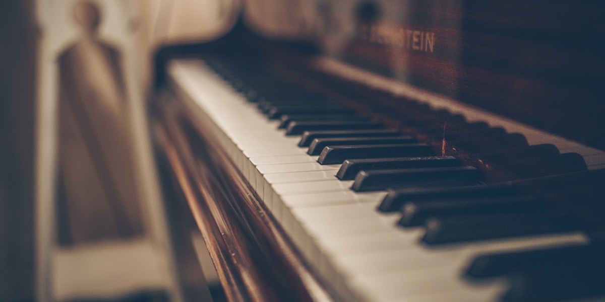 Hands playing a grand piano